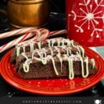 Three chocolate peppermint biscotti on a plate.