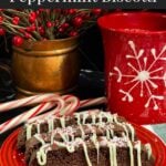 Three chocolate peppermint biscotti on a plate.