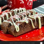 Three chocolate peppermint biscotti on a plate.