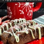 Three chocolate peppermint biscotti on a plate.