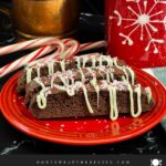 Three chocolate peppermint biscotti on a plate.