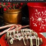Three chocolate peppermint biscotti on a plate.