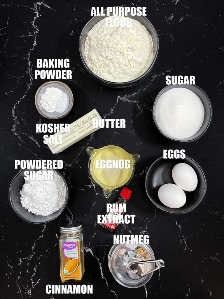 Eggnog muffin recipe ingredients on a dark surface.