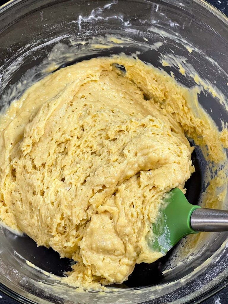 Eggnog muffin batter after resting for 15 minutes in a glass bowl.