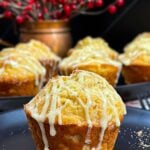 Eggnog muffin garnished with grated nutmeg on a dark plate.