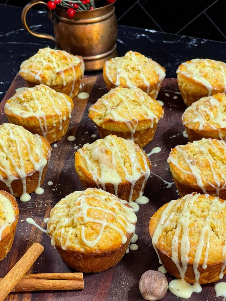 Eggnog muffins on a dark wooden board.