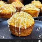 Eggnog muffins on a dark plate.