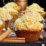 Eggnog muffins on a dark wooden board.
