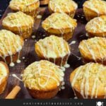 Eggnog muffins on a dark wooden board.