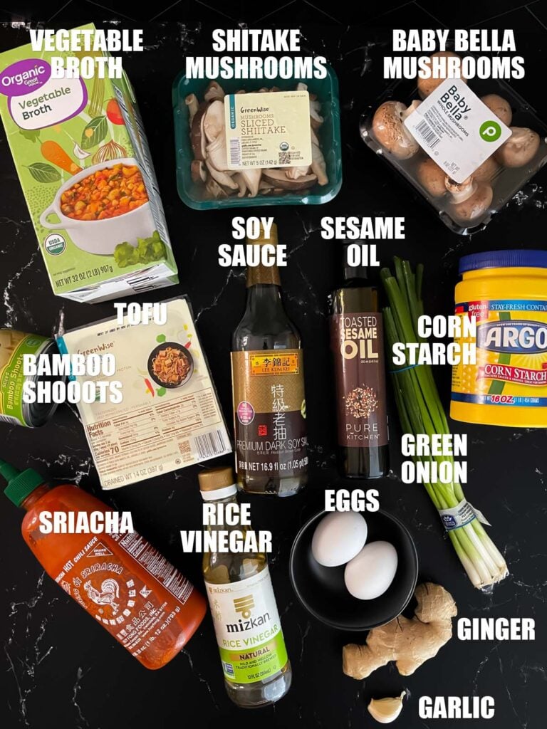 Vegetarian hot and sour soup recipe ingredients on a dark surface.