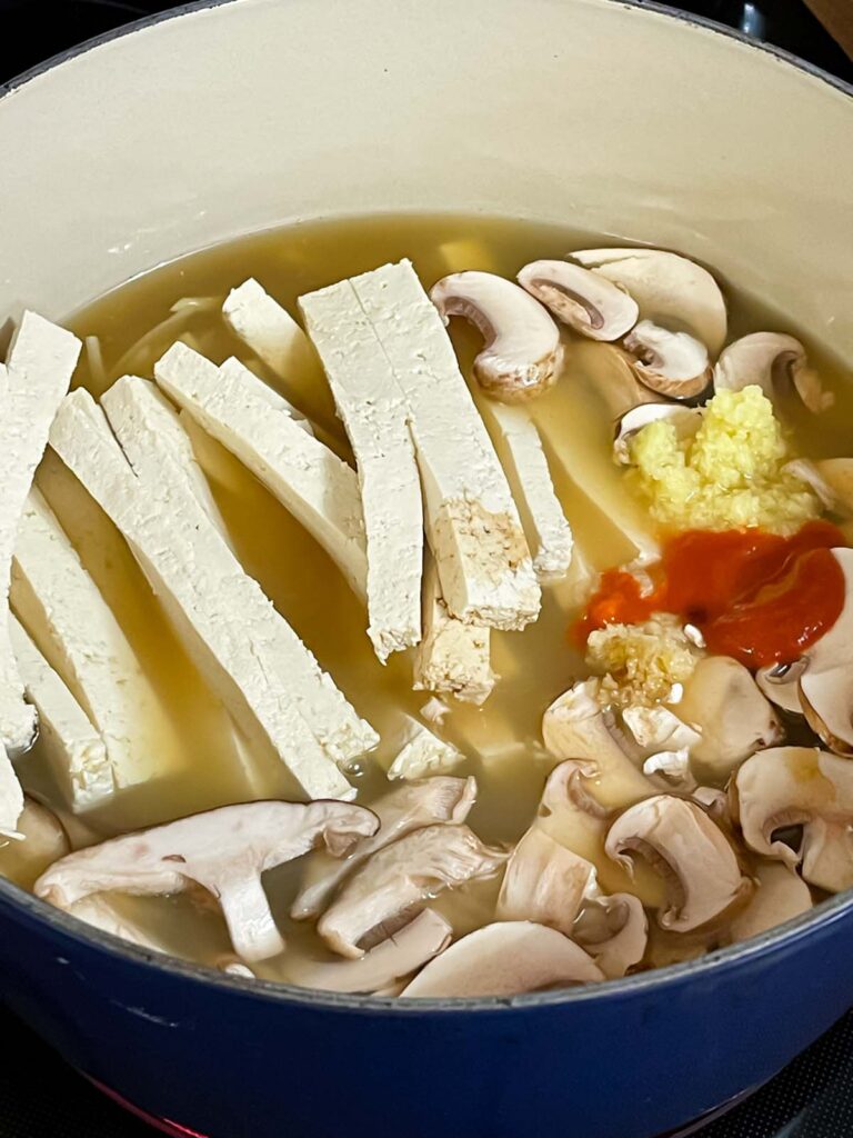 Hot and sour soup ingredients in a dutch oven.