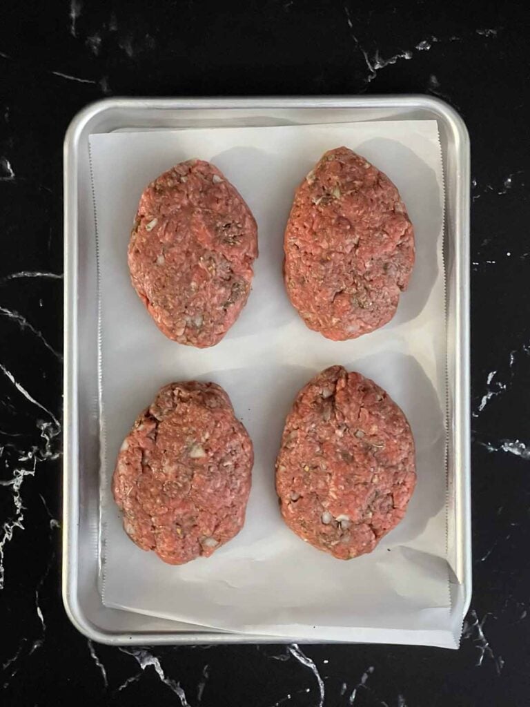 Raw Salisbury steak patties shaped and ready to cook
