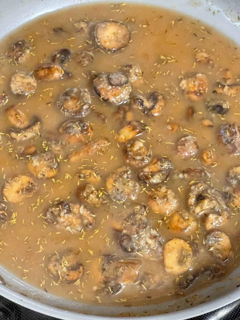 Beef broth added to mushrooms to make mushroom gravy