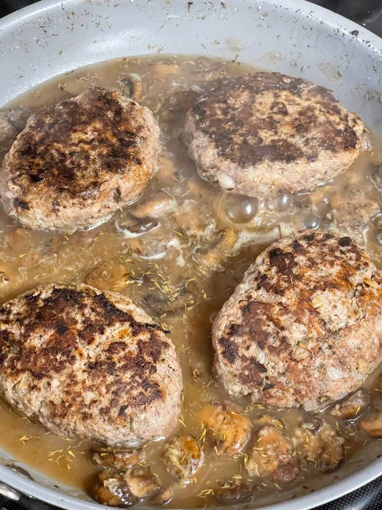Salisbury steak patties returned to skillet with mushroom gravy