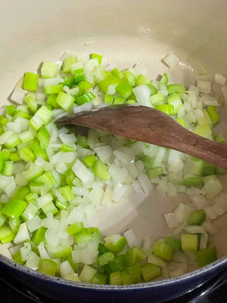 Onions and celery in a dutch oven.