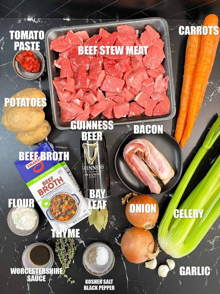 Ingredients for Guinness Beef Stew on a dark background.