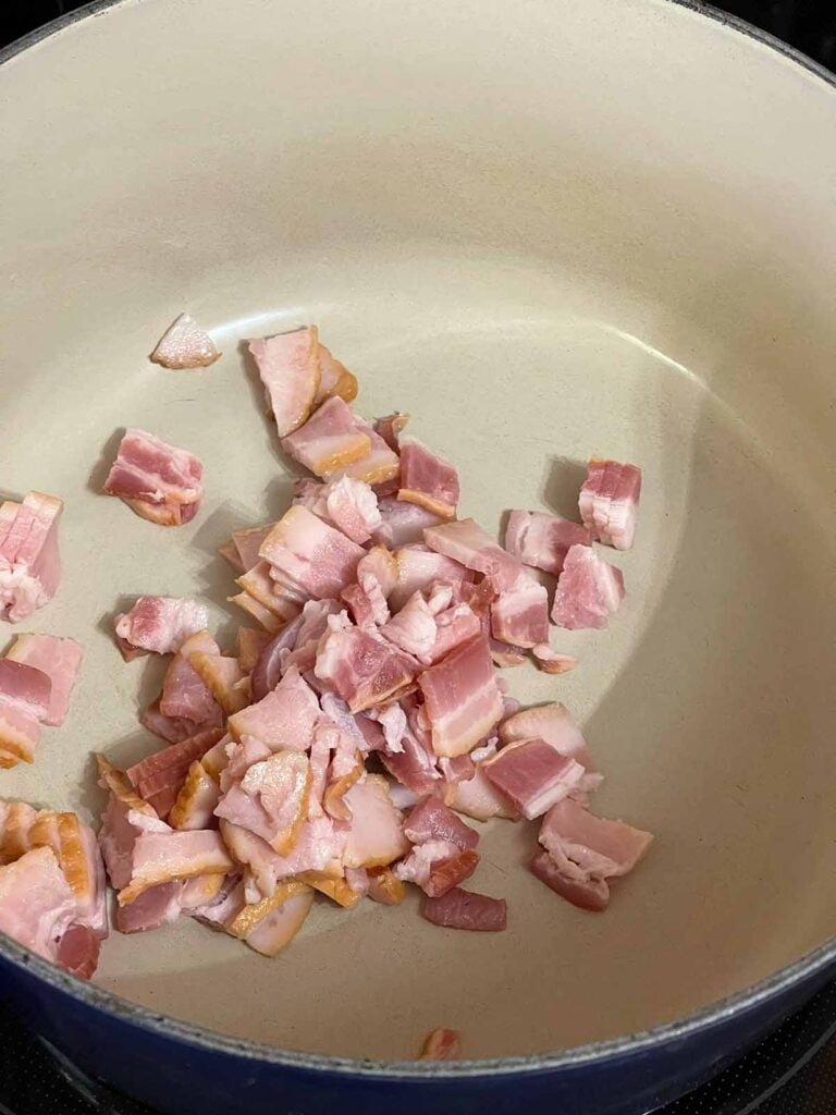 Raw bacon in a dutch oven.