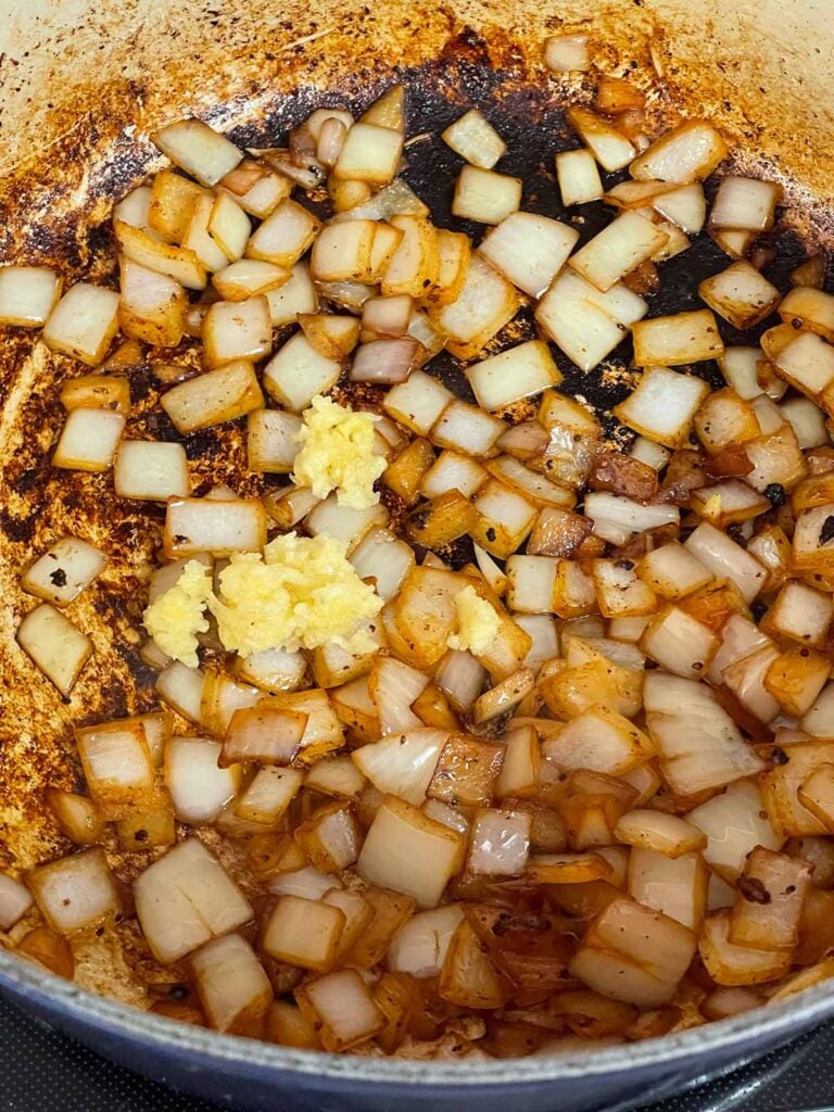 Browned onions with garlic in a dutch oven.