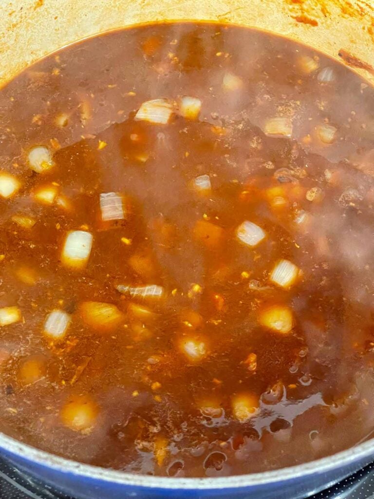 A broth cooking in a dutch oven.