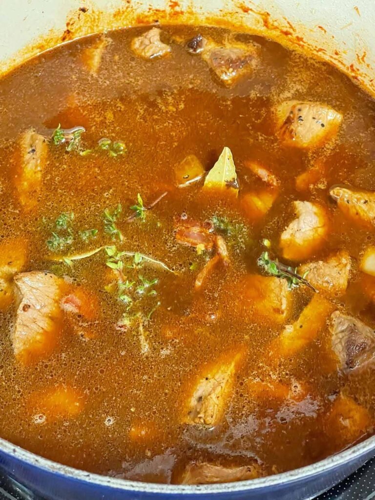 Irish stew cooking in a dutch oven.