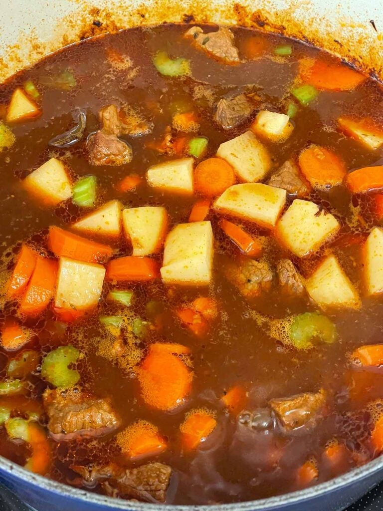Irish stew cooking in a dutch oven.