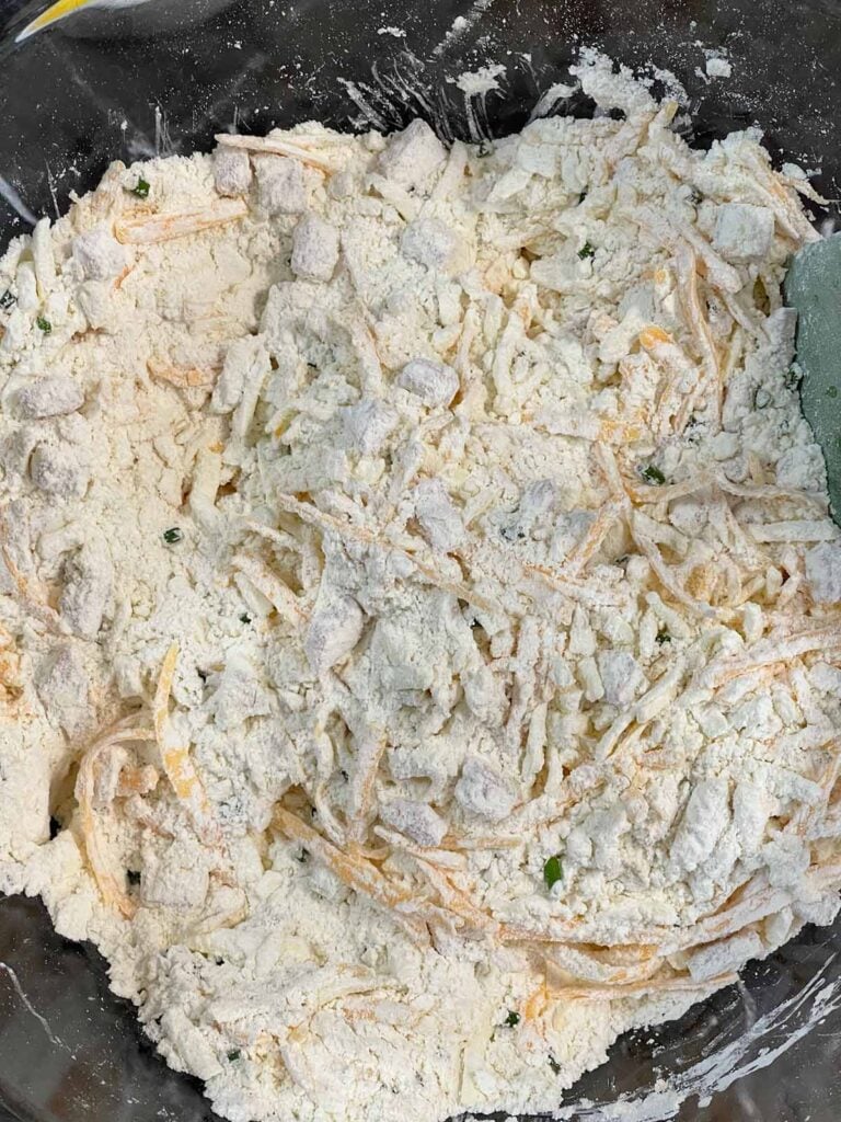 Add ins tossed with the dry ingredients in a glass bowl for the scones.