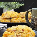 Ham and cheese scone on a dark plate garnished with chopped chives.