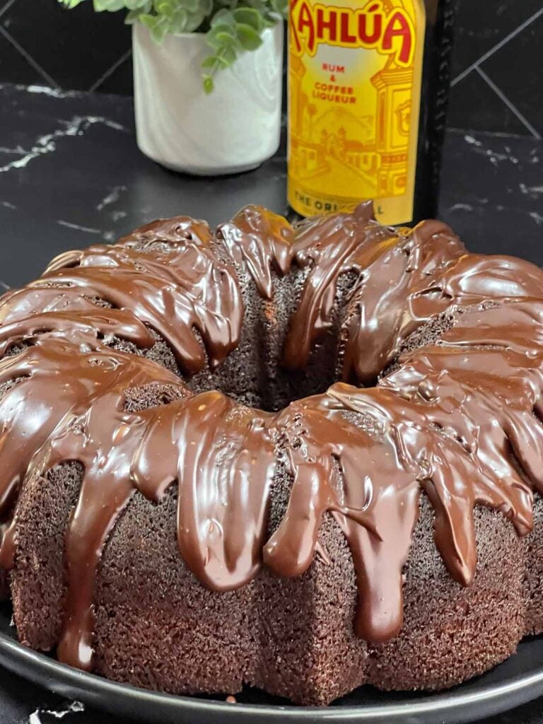 Chocolate Kahlúa cake on a dark platter.