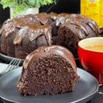 A slice of chocolate Kahlúa cake on a dark plate.