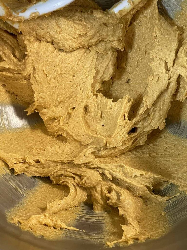 Egg and vanilla beat into the wet ingredients for peanut butter blossoms.