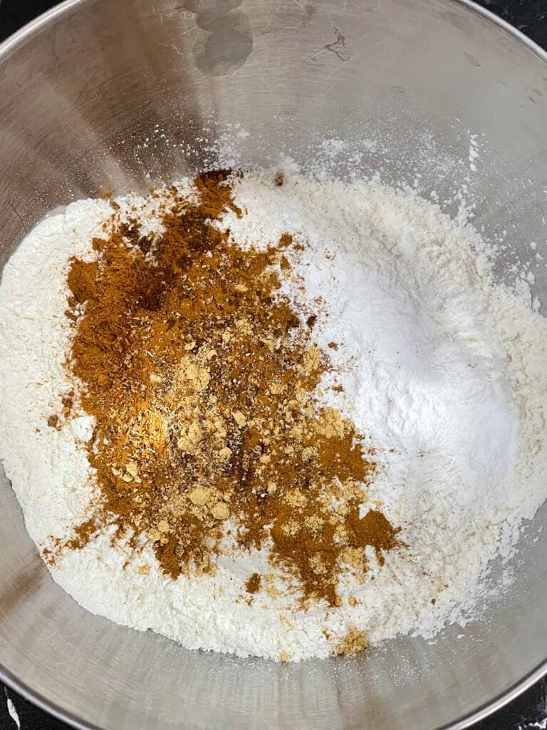 Dry ingredients for sweet potato coffee cake in a metal bowl.