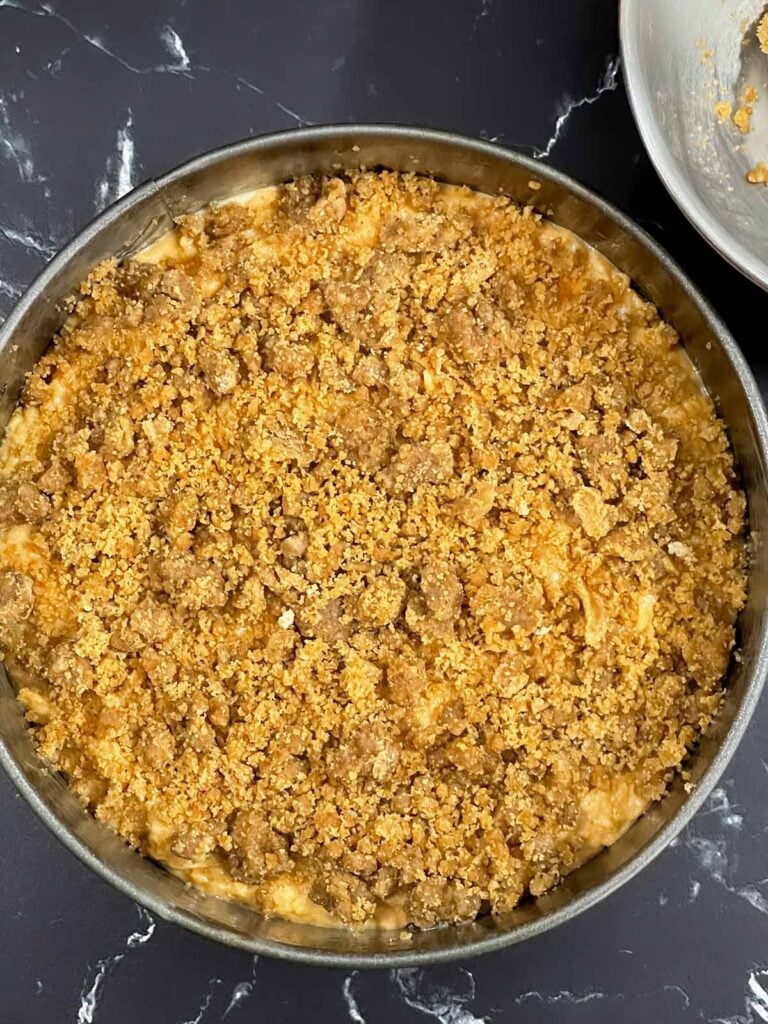 Streusel topping spread evenly over the sweet potato coffee cake batter in the springform pan.