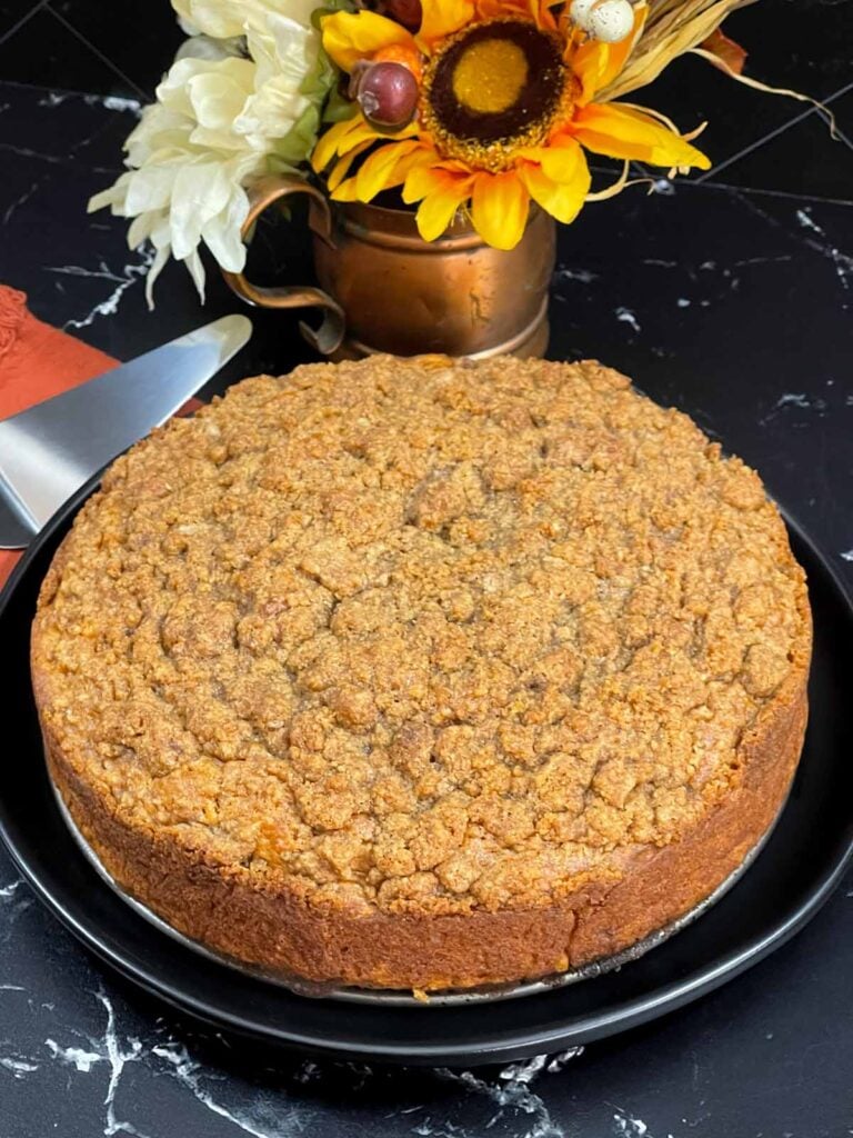 Sweet potato coffee cake on a dark plate.