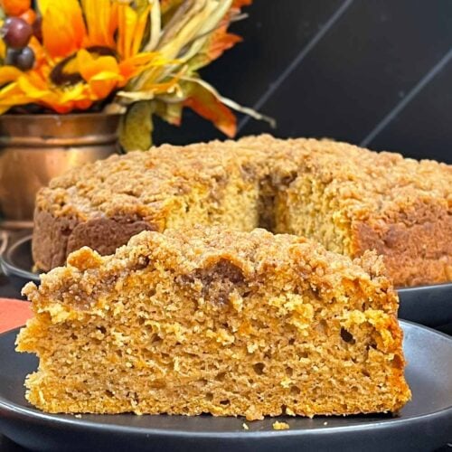 A slice of sweet potato coffee cake on a dark plate.