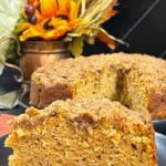 A slice of sweet potato coffee cake on a dark plate.