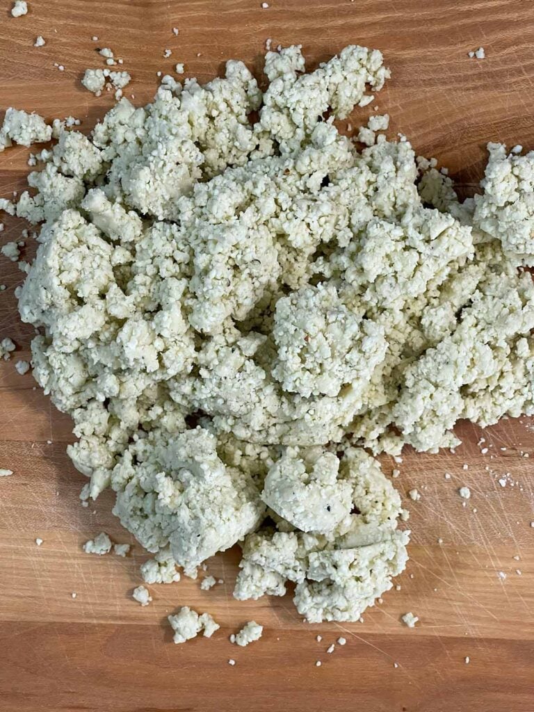 Blue cheese wafer dough dumped on a wooden board.