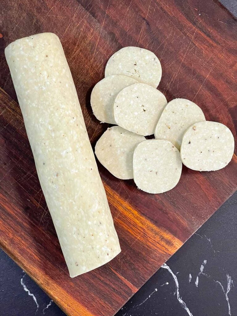 Sliced blue cheese wafers dough on a wooden board.