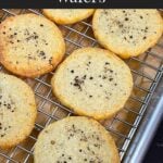 Blue cheese wafers on a wire rack place in a parchment paper lined baking sheet.