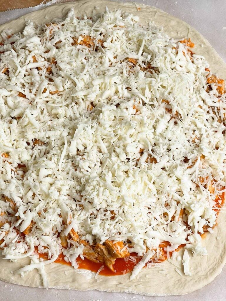 An unbaked buffalo chicken pizza.