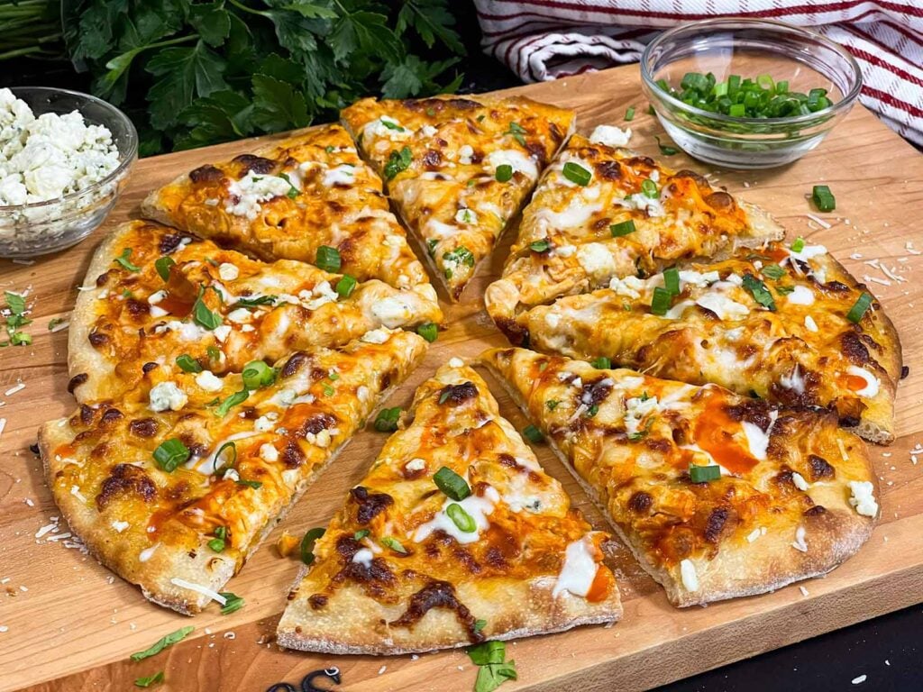 Buffalo Chicken Pizza on a wooden cutting board.