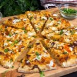 Buffalo Chicken Pizza on a wooden cutting board.