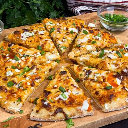 Buffalo Chicken Pizza on a wooden cutting board.