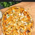 A buffalo chicken pizza on a cutting board.