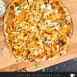 A buffalo chicken pizza on a cutting board.