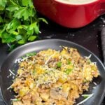 Chicken and wild rice casserole on a dark plate.