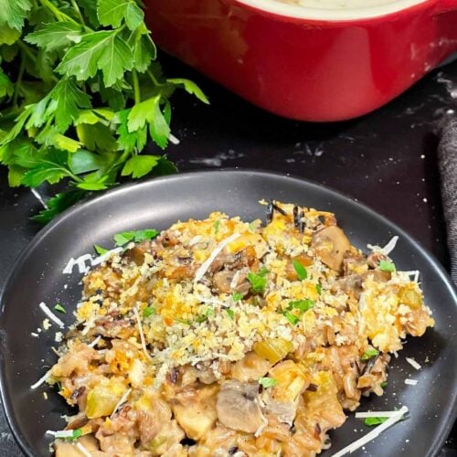 Chicken and wild rice casserole on a dark plate.