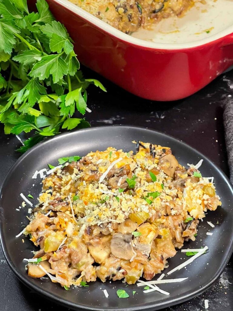 Chicken and wild rice casserole on a dark plate.