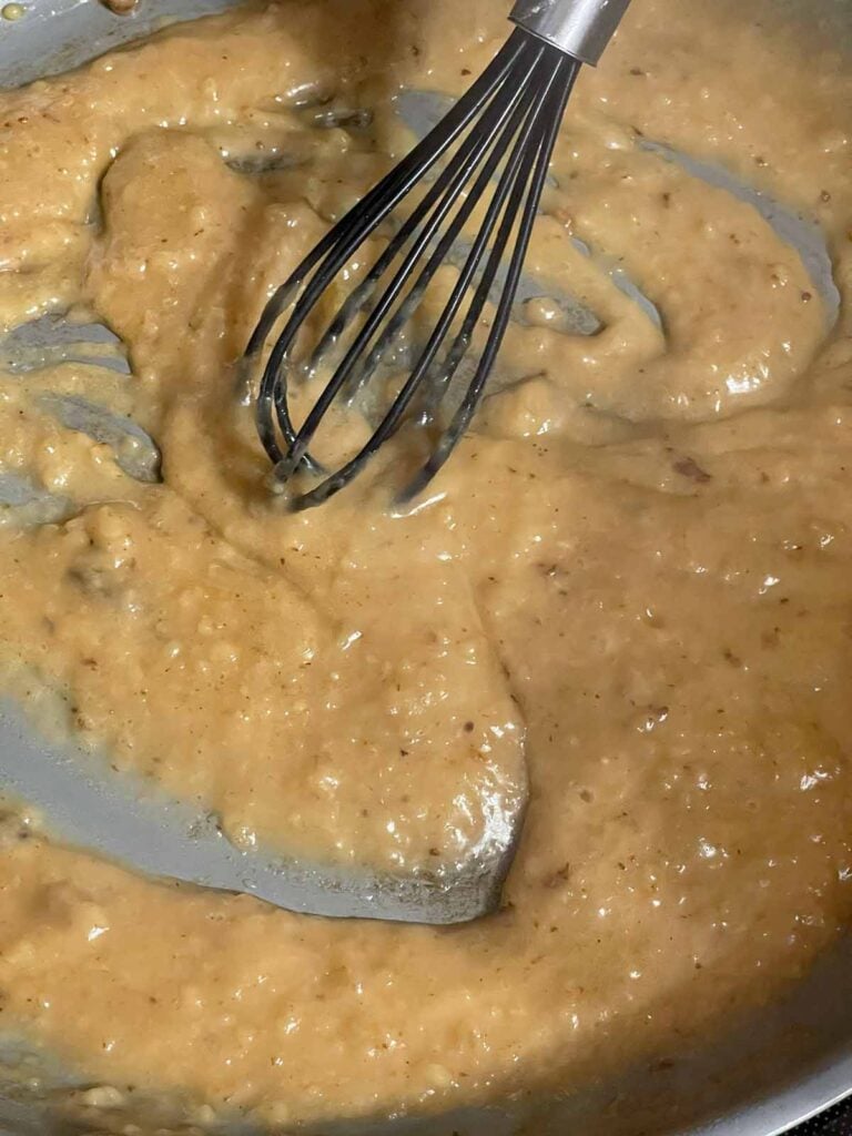 Sauce coming together in a skillet.