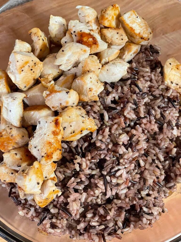 Cooked chicken and wild rice in a bowl.