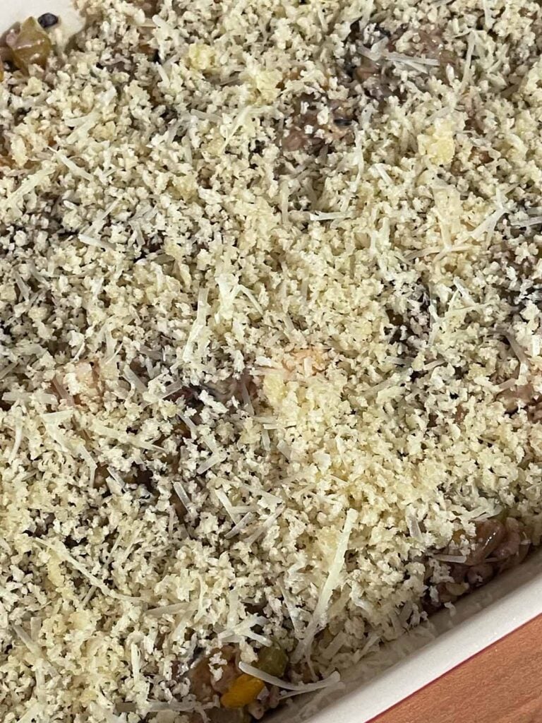 Breadcrumbs sprinkled over a casserole.